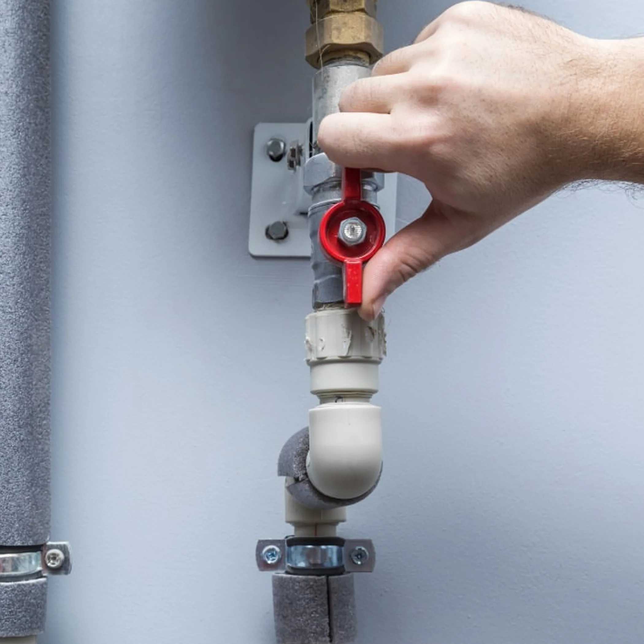 exposed pipes and shutoff valve
